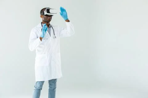 Positive experienced doctor using VR glasses Stock Photos