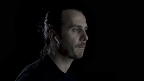 An positive face young man with long haired listening music with Airpods and  Stock Footage 134543054
