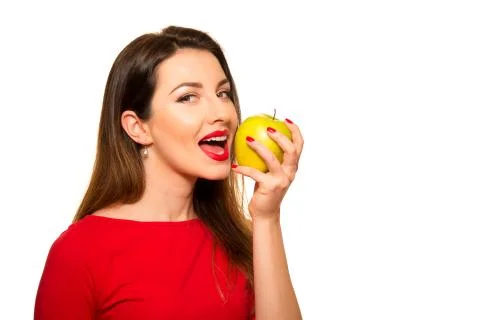 Positive Female Biting a Big Green Apple Fruit Smiling on White Background Stock Photos
