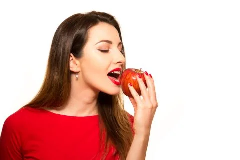 Positive Female Biting a Big Red Apple Fruit Smiling on White Background Eati Stock Photos
