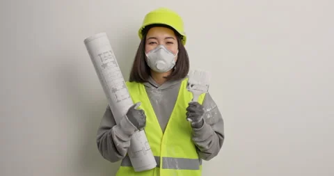 Positive female construction worker or repairer dances with joy poses with Stock Footage 155252102