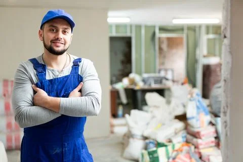 Positive foreman posing on indoor construction site Stock Photos