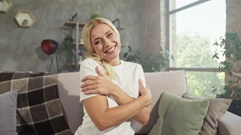 Positive glad inspired lady cuddle herself enjoy warmth Stock Footage 166902607