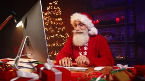 Positive glad inspired santa worker typing keyboard computer Stock Footage 159694692