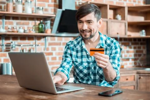 Positive good looking man using his credit card Stock Photos