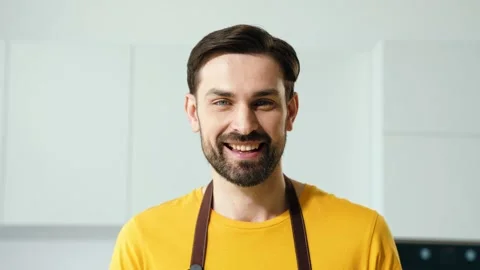 Positive guy ready do tasty supper cross arms in kitchen Stock Footage 165386398