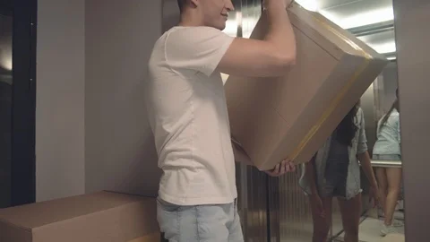 Positive guy takes boxes with things that his girlfriend gives him Stock Footage 113751766