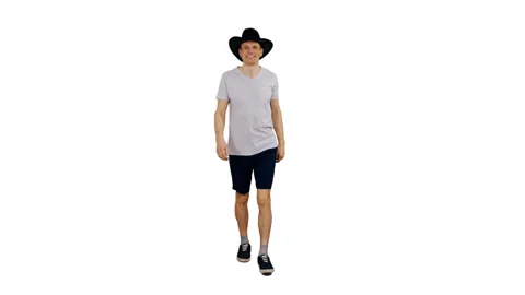 Positive guy walking in white T-shirt and black cowboy hat, alpha channel Stock Footage 90050627