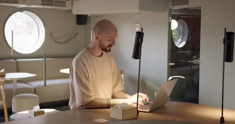 Positive guy working on laptop at cozy cafeteria Stock Footage 159083145