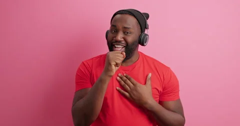 Positive handsome dark skinned man pretends being on stage sings song wants to Stock Footage 149917023