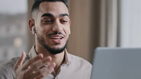 Positive hispanic young man guy male teacher wear wireless earphones look at Stock Footage 198747940