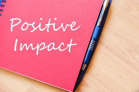 Positive impact write on notebook Stock Photos