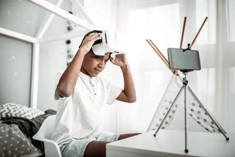 Positive joyful boy testing virtual reality glasses Stock Photos
