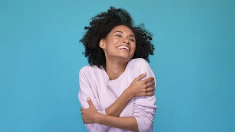 Positive lady cuddle shoulders hands isolated blue color background Stock Footage 167358326