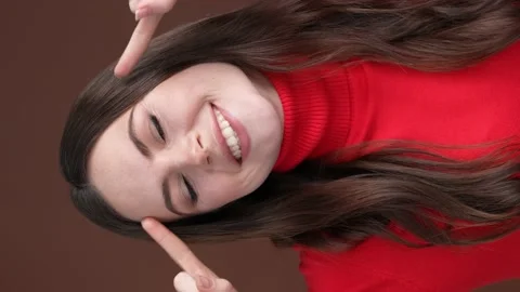 Positive lady make different faces isolated brown color background Stock Footage 189494564