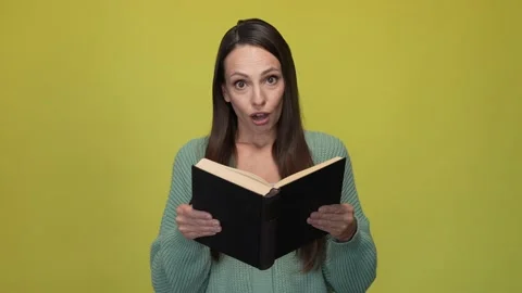 Positive lady read printed book impress isolated vibrant color background Video stock 167360849