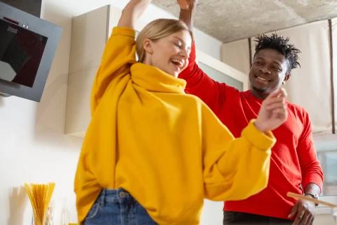 Positive lady smiling while dancing with happy man Stock Photos