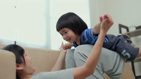 Positive little boy playing lying plane fly on sofa in living room with happy. Stock-Footage 169914733
