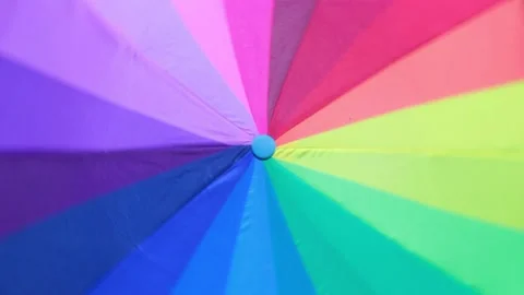 Positive Looped Background of Rotating Multicolor Umbrella Stock Footage 203912745