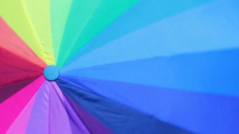 Positive Looped Background of Rotating Multicolor Umbrella Stock Footage 203912759