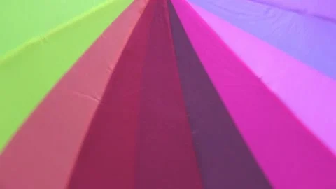 Positive Looped Background of Rotating Multicolor Umbrella Stock Footage 203912770