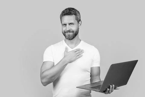 Positive man programmer with laptop isolated on yellow background. man Stock Photos
