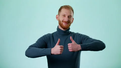 Positive Man Showing Double Thumbs Up And Smiles To Camera, Showing Ok Stock Footage 170189669