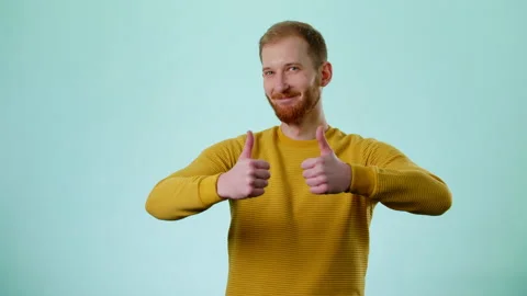 Positive Man Showing Double Thumbs Up And Smiles To Camera Stock Footage 170191753