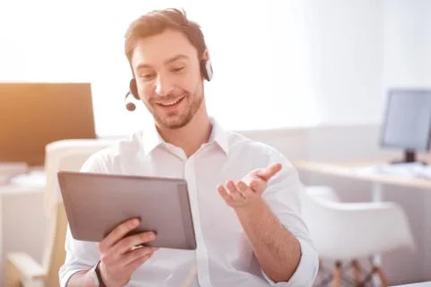 Positive man sitting at the table Stock Photos