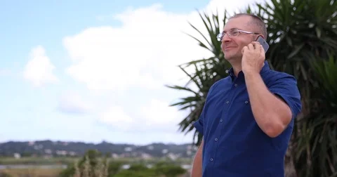 Positive Man Talking Mobile Phone a Technology Gadget near a Air Plane Landing Stock Footage 76998522
