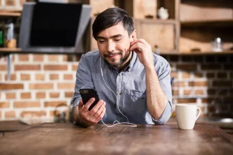 Positive man using his smartphone Stock Photos