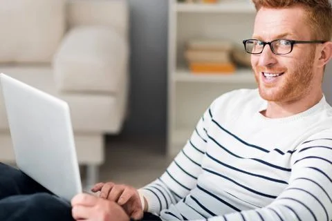 Positive man using laptop Foto stock