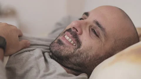 Positive man Waking Up In Bed And Smiling Stock Footage 163034276