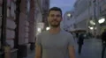 The positive man walk in the evening street. Wide angle. Real time capture 4k or 4k+ Resolution