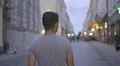 The positive man walk in the evening street. Wide angle. Real time capture 4k or 4k+ Resolution