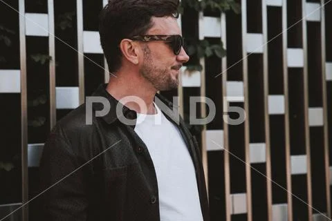 Positive matured man resting outdoor. Freelance profession concept Stock Photos