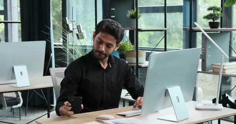 Positive Middle Eastern Businessman Using Phone at Work Stock Footage 254441072