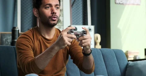 Positive Middle Eastern Man Playing Video Games on Sofa Stock Footage 254505084