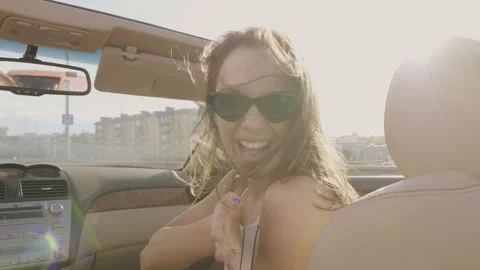 Positive model riding and having fun in sunglasses at sunset Stock Footage 146108772