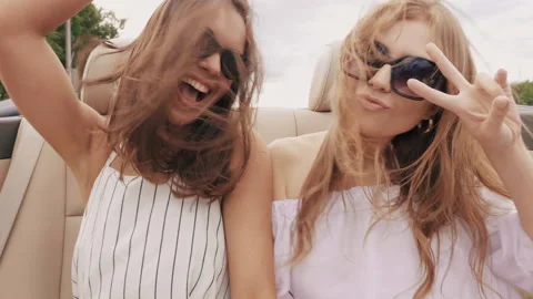 Positive models riding and having fun in sunglasses. Showing peace sign Stock Footage 146108132