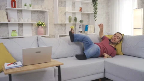 Positive motivated disabled dwarf young man smiling happily at home and enjoying Stock Footage 230968968