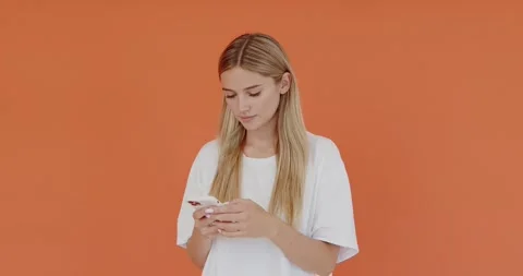 Positive optimistic female using smartphone with happy facial expression Stock Footage 204940822