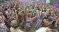 Positive people waving hands to music at concert, spraying paint HD Footage