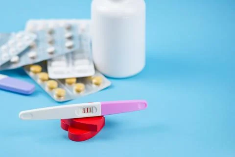Positive pregnancy test on blue background, family planning. IVF theme, inf.. Stock Photos