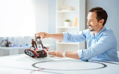 Positive professional engineer testing robot 스톡 사진
