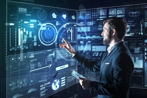 Positive programmer smiling while pointing to the diagrams 스톡 사진