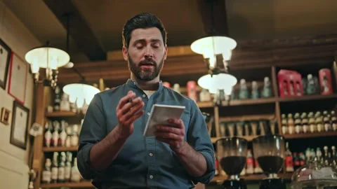 Positive restaurant worker using pen and notepad while talking with clients Stock Footage 260873716