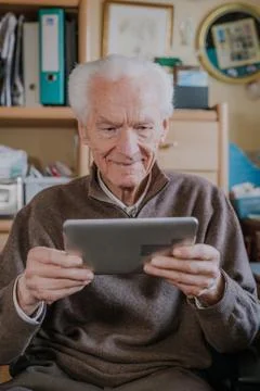 Positive Senior using Digital Tablet Stock Photos