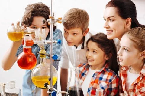 Positive smart boy showing an experiment Stock Photos
