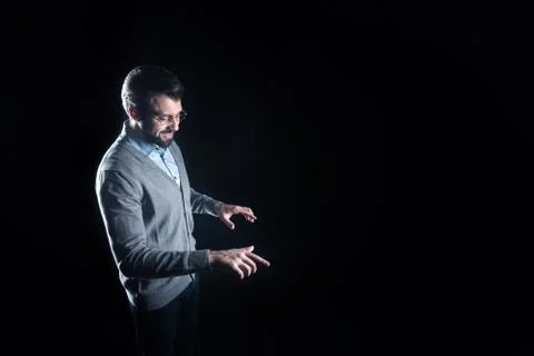 Positive smart man looking at the transparent device Stock Photos